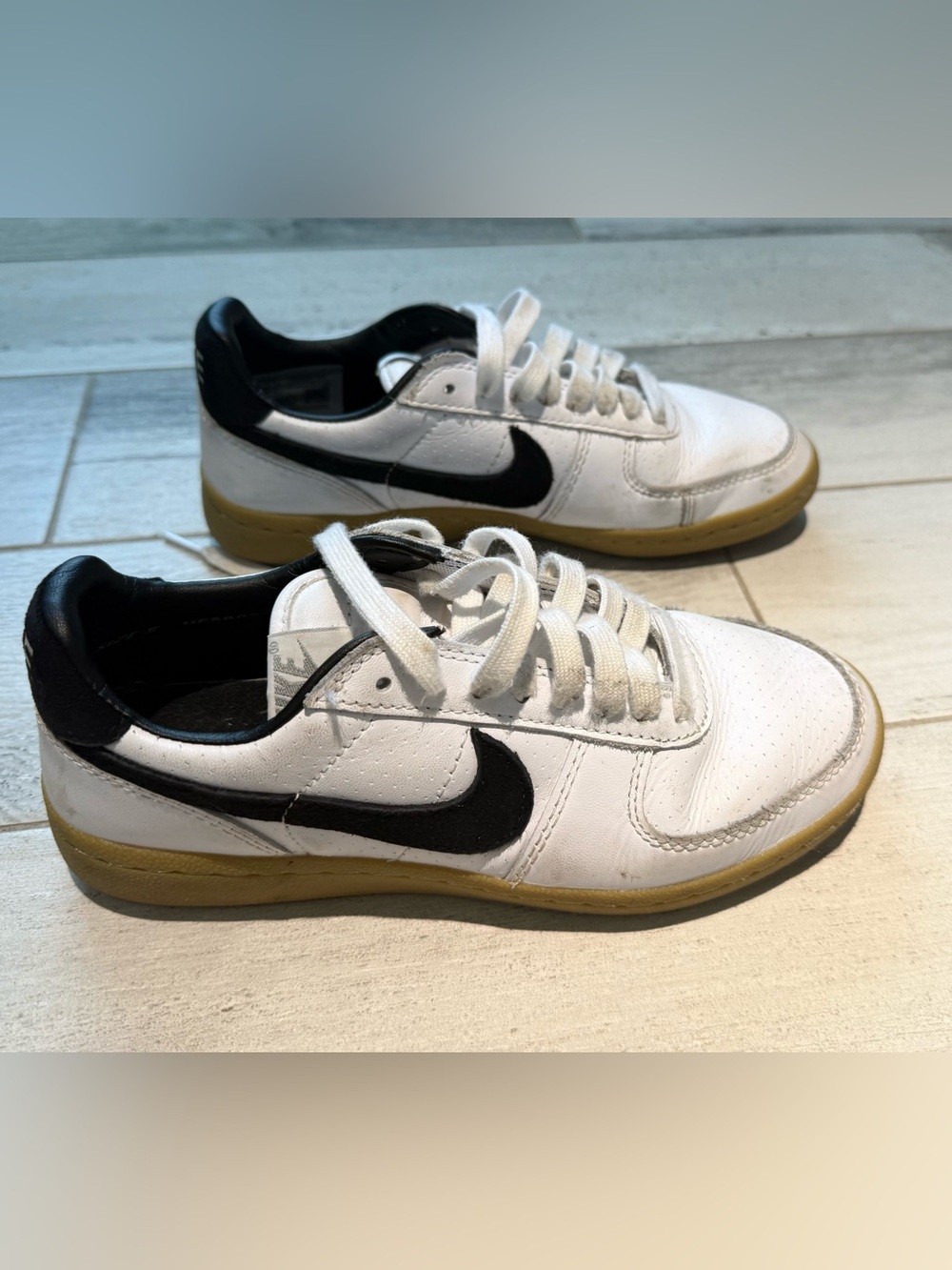 Nike White Low-Top Sneakers with Black Swoosh and Gum Outsole